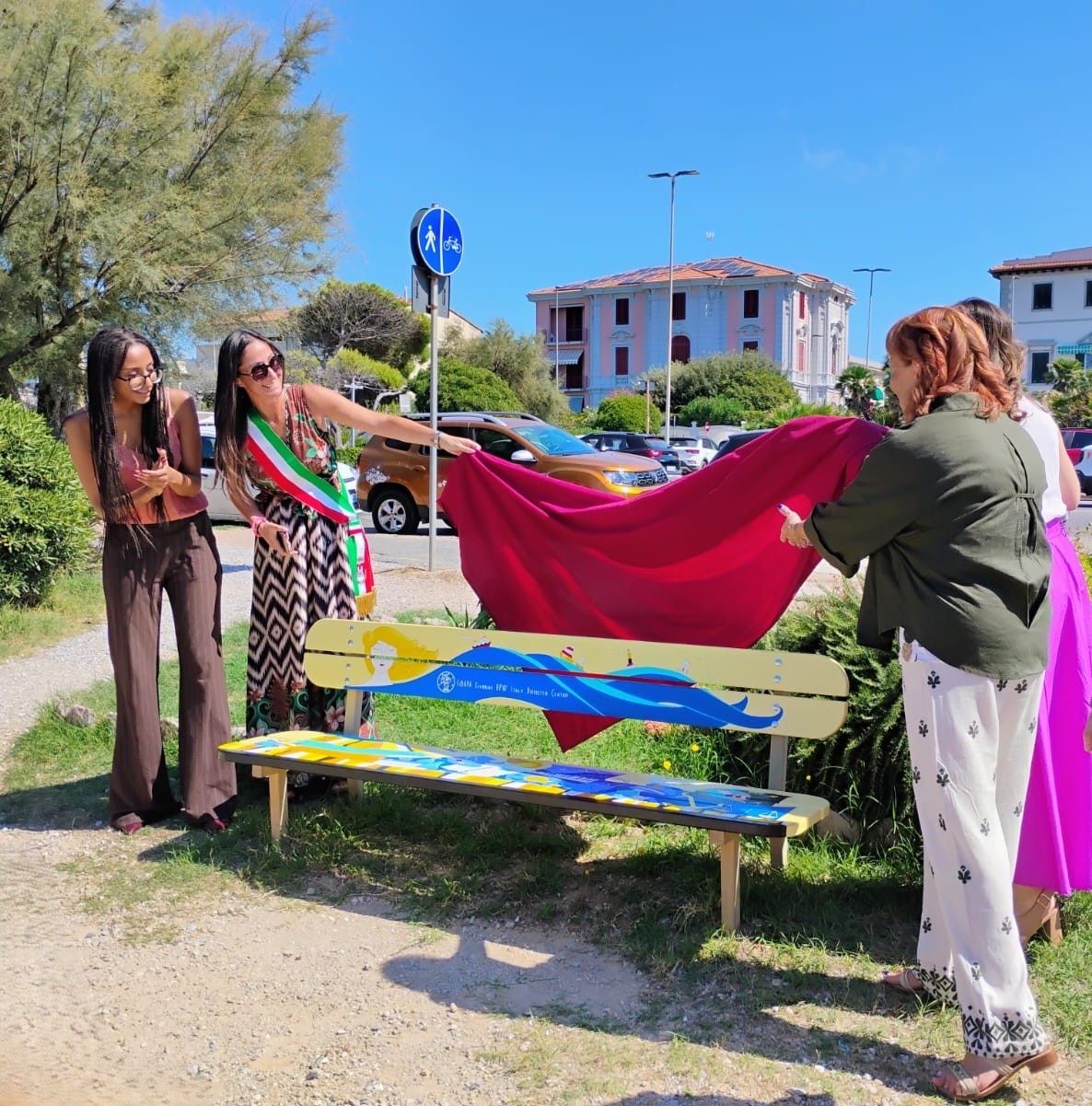 Panchina decorata FIDAPA sul lungomare di Livorno, con figure femminili e simboli delle arti e delle professioni.